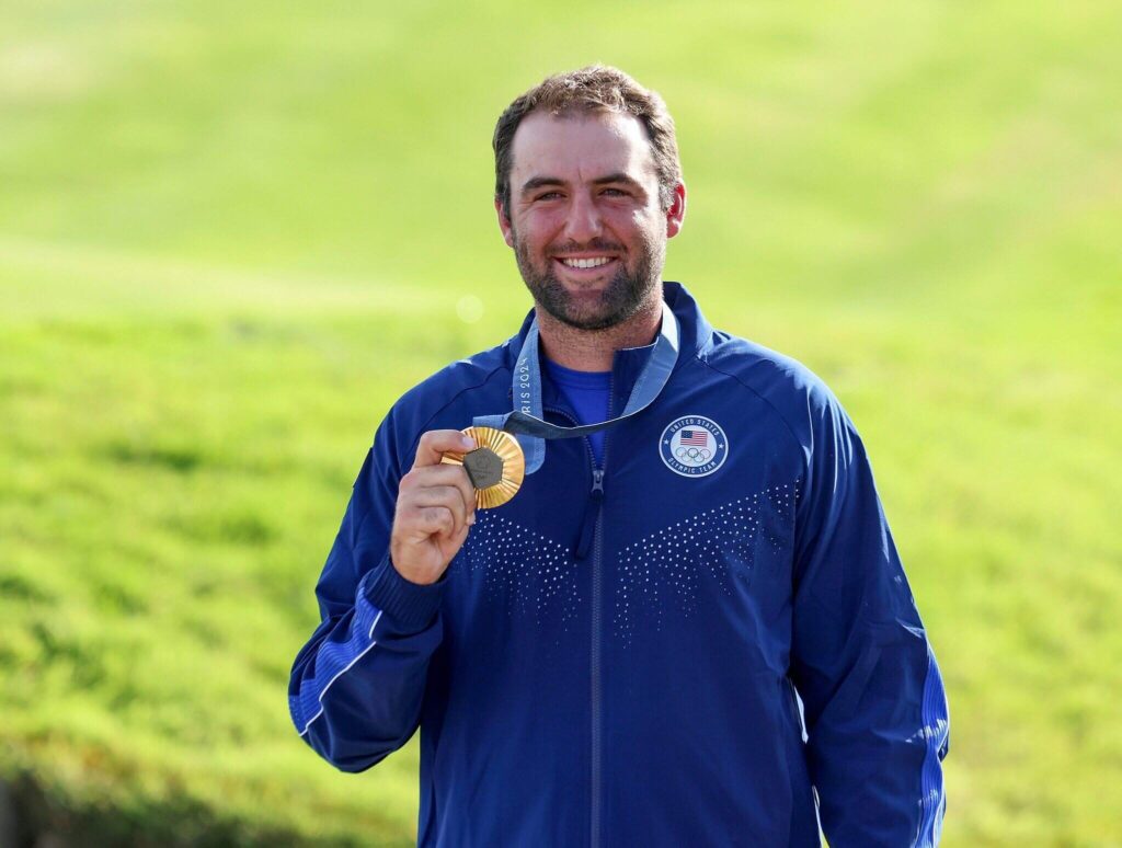 Scottie Scheffler holding gold medal.