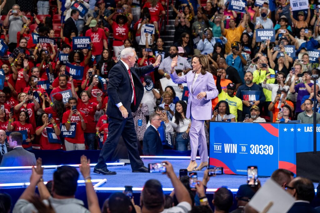 Kamala Harris gives hi-five to Tim Walz.