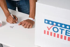 A Person with a Wristband Casting a Vote.