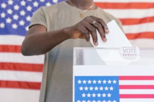 Person Putting his Vote on Ballot Box.