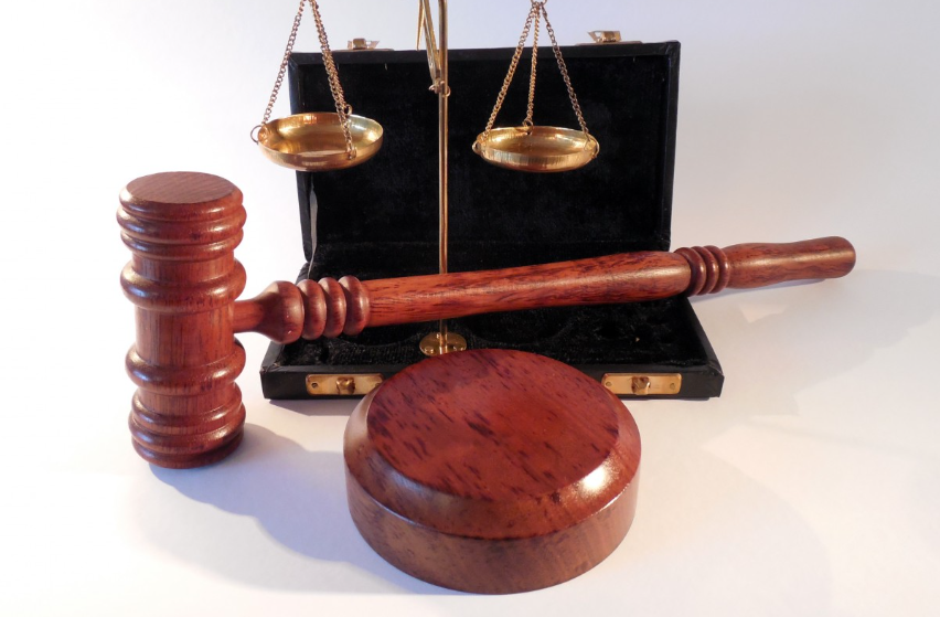 Symbols of Justice: Balancing Scales and Gavel.