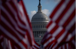 US Flag left and right. There is a building in the mid.