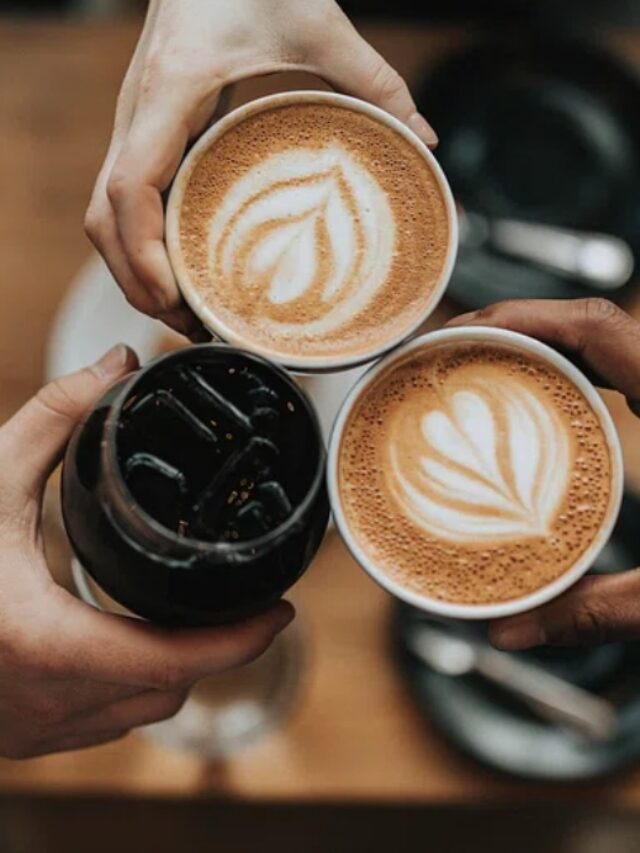 Three people cheering with iced coffee and lattes at Verve Coffee.