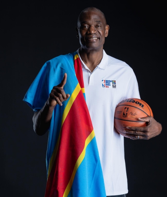 Dikembe Mutombo holding a ball.