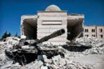 Two destroyed tanks in front of a mosque in Azaz, Syria. Photo Source: Christiaan Triebert (CC BY 2.0)