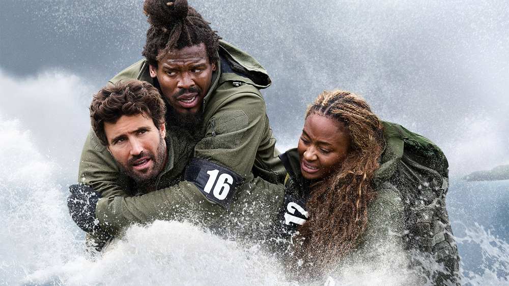Three recruits clad in tactical gear struggle through turbulent water as waves crash over them.