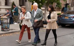 Steve Martin, Martin Short, and Selena Gomez walking together on a New York City street in a scene from Only Murders in the Building Season 5.