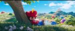 Mario in his red outfit resting under a tree in the Mushroom Kingdom with a serene landscape featuring a river, colorful hills, and Princess Peach's pink castle visible in the distance against a bright blue sky.