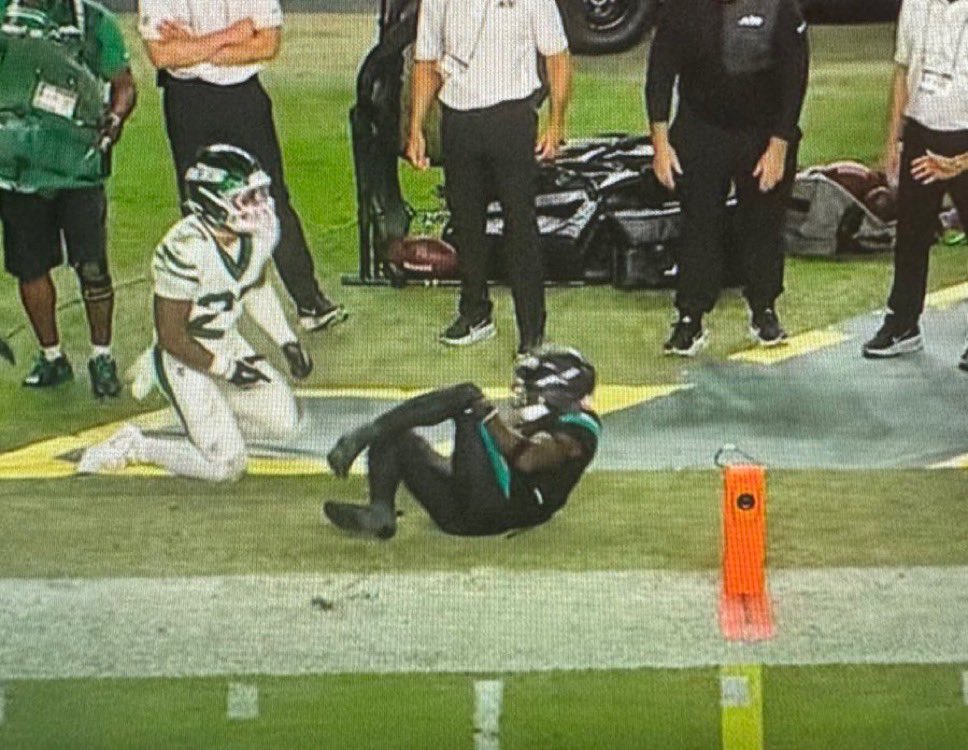 Tyreek Hill lying on the field after suffering a knee injury during the Dolphins vs Jets game at Hard Rock Stadium.