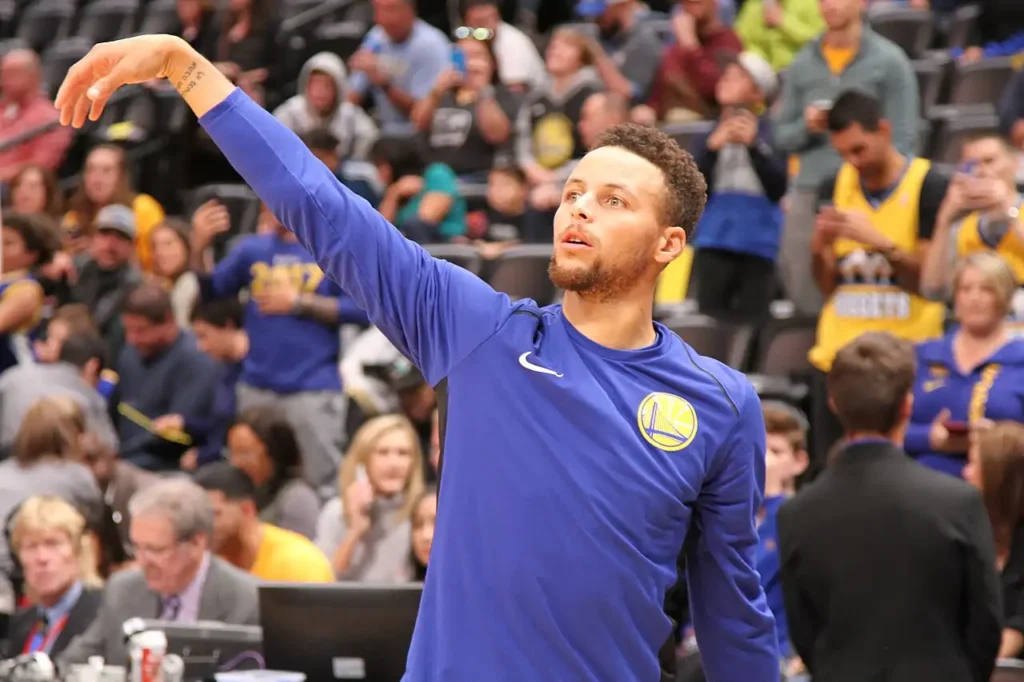 Stephen Curry handling the ball during Golden State Warriors pre-game warmups, foreshadowing his 27-point performance against the New York Knicks.