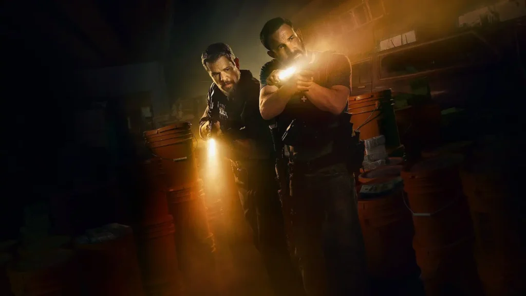 The ensemble cast of The Rip, including Kyle Chandler, Ben Affleck, Steven Yeun, Teyana Taylor, and Catalina Sandino Moreno, standing together in a scene.