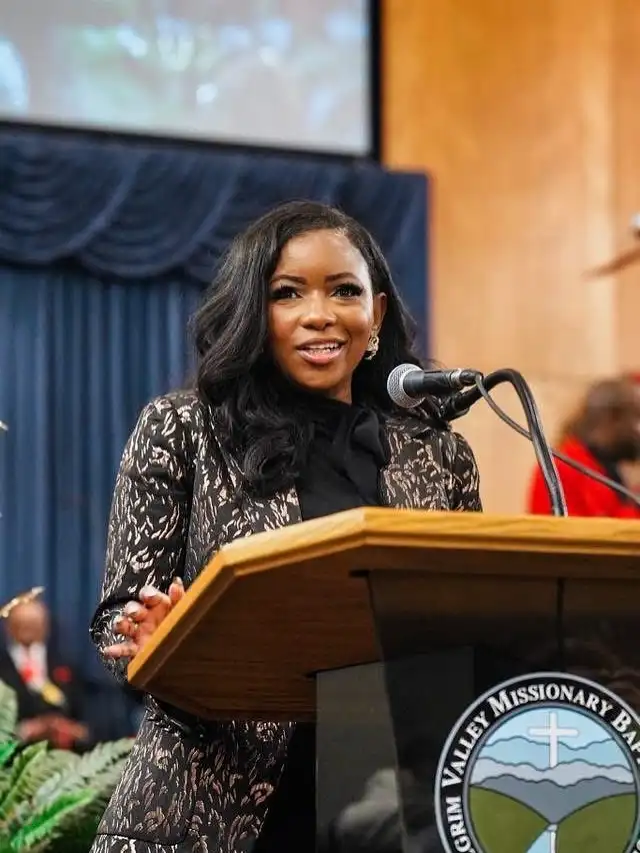 Jasmine Crockett speaking at a podium with a microphone during a public event in Fort Worth, Texas.