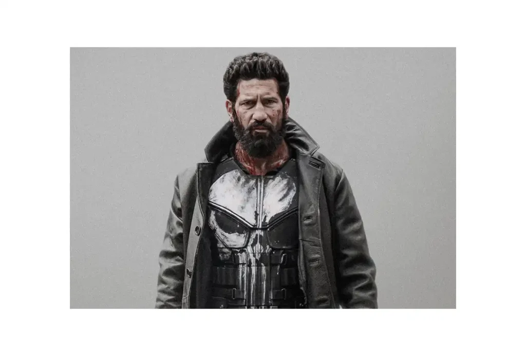 Battle-damaged Frank Castle in a dark coat and skull-emblem armor in promotional artwork for Punisher: One Last Kill.