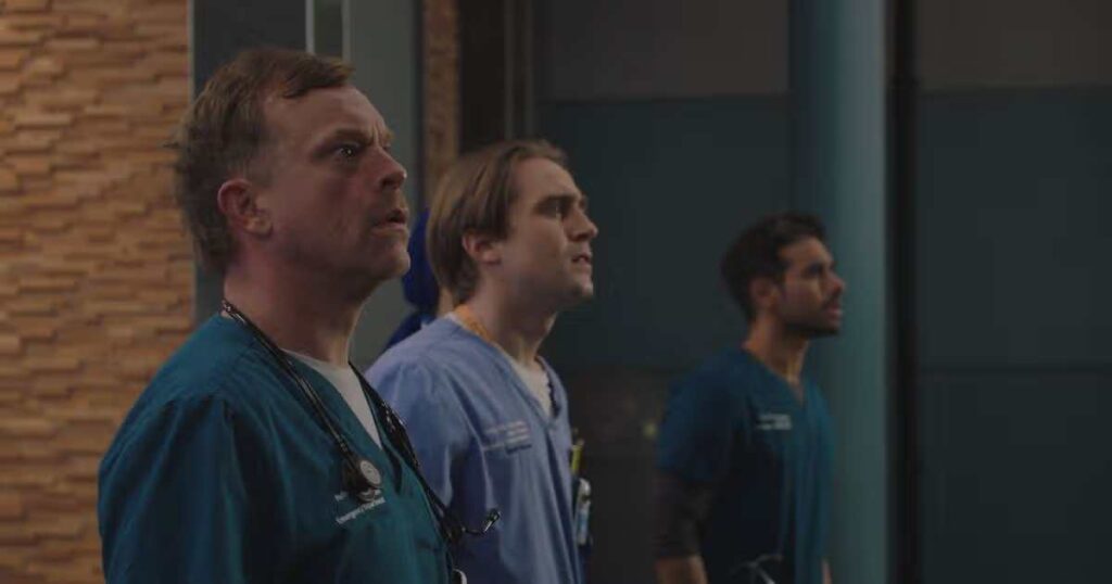 A dramatic scene from Casualty's 40th anniversary special showing the aftermath of a major explosion, with emergency services responding and hospital staff in shock as red alerts flash across screens.