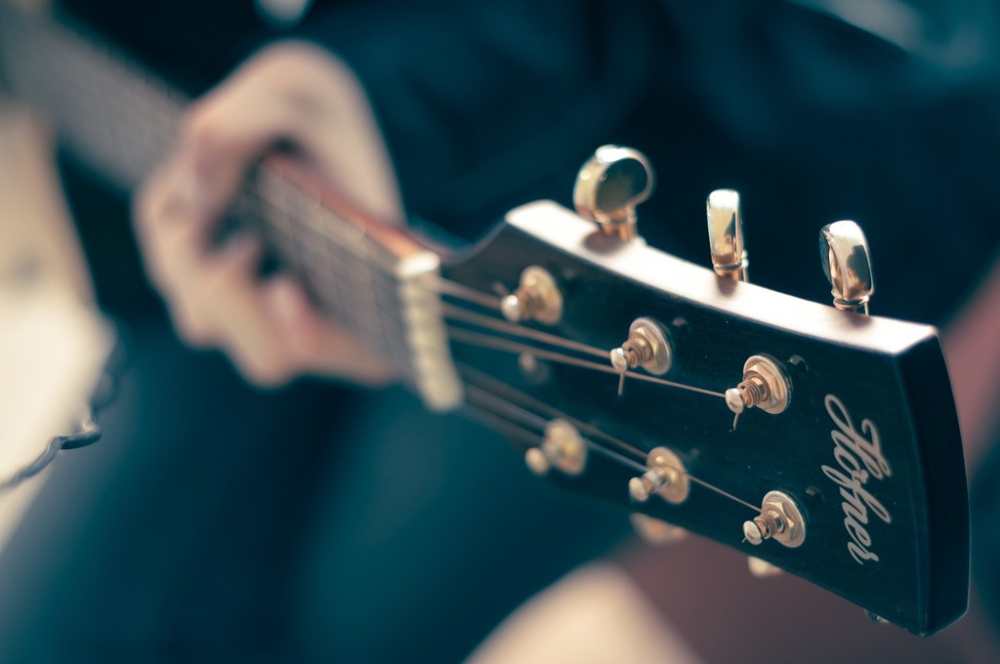 Acoustic guitar resting on a wooden surface.