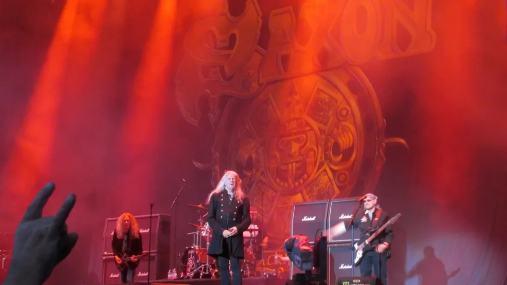 British heavy metal band Saxon performing on stage at an outdoor music festival.