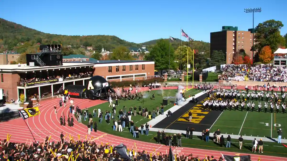 Appalachian State Mountaineers football players and marching band entering the field before a home game at Kidd Brewer Stadium