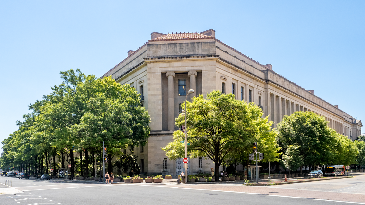 Exterior of the US Department of Justice Robert F. Kennedy headquarters building in Washington DC with columns and inscription