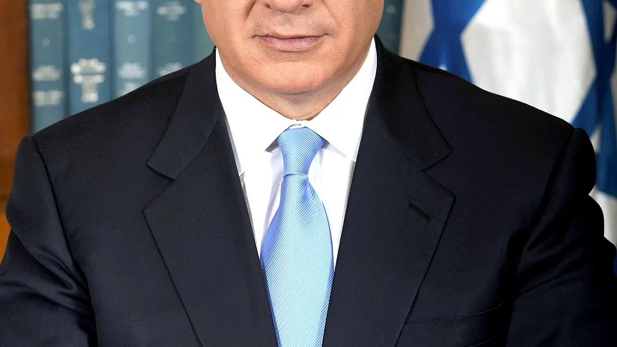 Israeli Prime Minister Benjamin Netanyahu in a dark suit and striped tie.