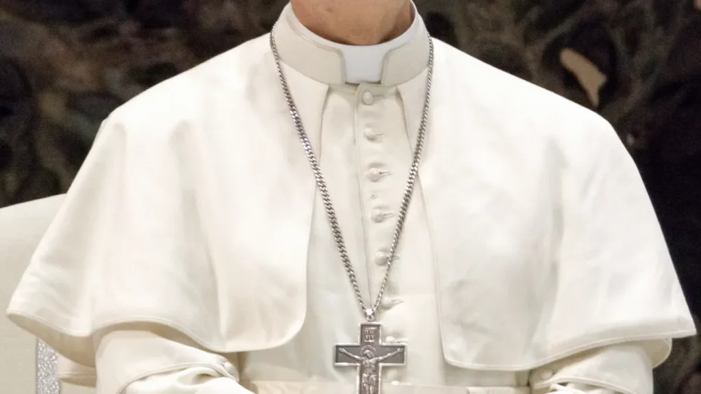 Official portrait of Pope Leo XIV, the first U.S.-born pope, wearing white papal vestments and a silver pectoral cross