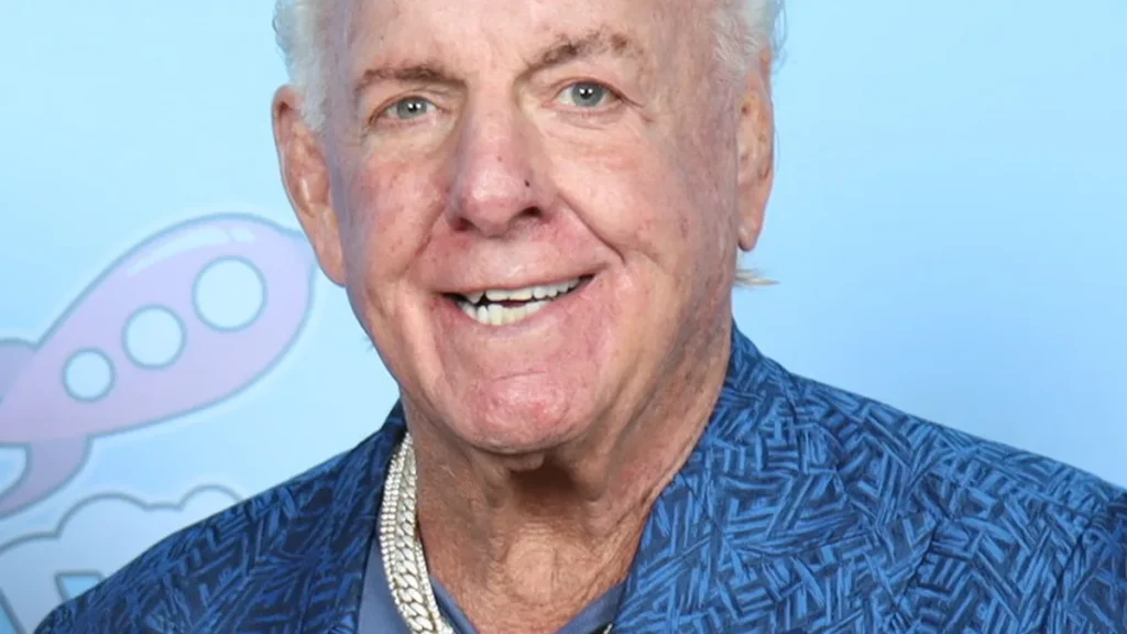 Professional wrestler Ric Flair posing at a fan convention photo op in 2023