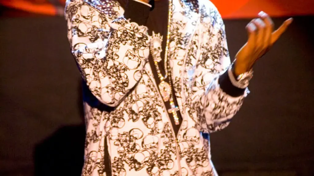 Shawn Jay-Z Carter performing on stage with a microphone in front of an arena audience.