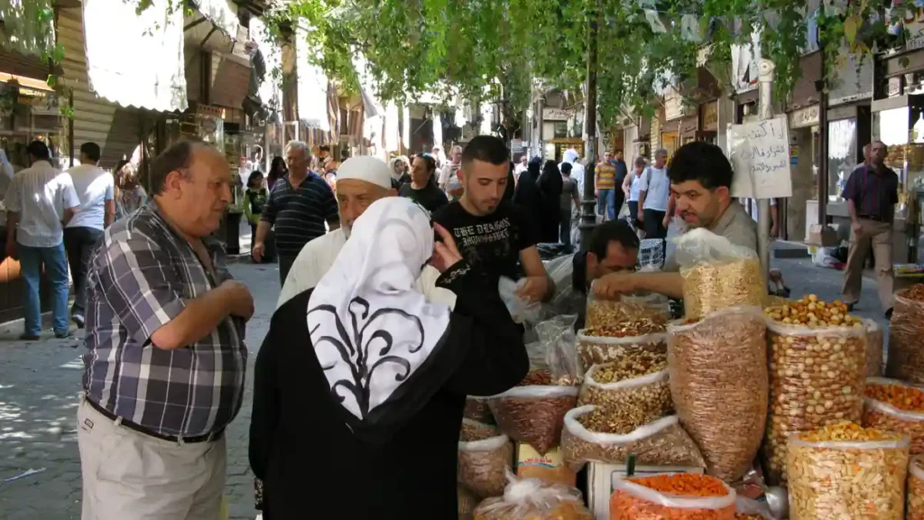 A market street in Damascus showing shopkeepers and goods amid Syria's economic crisis and soaring prices